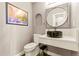 Stylish half-bathroom with unique vessel sink, modern fixtures, and elegant design at 10293 E Sheri Ln, Englewood, CO 80111