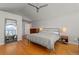 Spacious primary bedroom with hardwood floors, ceiling fan, large windows and a dresser at 10293 E Sheri Ln, Englewood, CO 80111