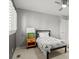 Charming bedroom features a ceiling fan, neutral walls and carpet, and a modern side table at 10293 E Sheri Ln, Englewood, CO 80111