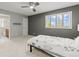 Bedroom with dark gray accent wall, white shutters, an ensuite bathroom, and neutral carpet at 10293 E Sheri Ln, Englewood, CO 80111