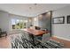 Modern dining room with large window, stylish lighting, fireplace, and contemporary furnishings at 10293 E Sheri Ln, Englewood, CO 80111