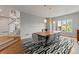 Stylish dining room featuring a large table, modern chairs, and three pendant lights at 10293 E Sheri Ln, Englewood, CO 80111