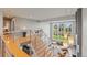 Bright, open foyer featuring hardwood floors, modern railings, and natural light cascading through large windows at 10293 E Sheri Ln, Englewood, CO 80111