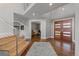 Spacious foyer featuring a modern staircase, hardwood floors, and a stylish front door at 10293 E Sheri Ln, Englewood, CO 80111