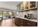Modern kitchen featuring stainless steel appliances, sleek cabinetry, and a coffee bar area with sliding glass doors to an outdoor patio at 10293 E Sheri Ln, Englewood, CO 80111