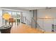 Bright landing with modern railing, wood floors, and an adjacent dining area at 10293 E Sheri Ln, Englewood, CO 80111