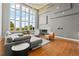 Elegant living room with high ceilings, large windows, and a modern fireplace and seating area at 10293 E Sheri Ln, Englewood, CO 80111