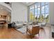 Bright, open living room with expansive windows, hardwood floors, and modern furnishings at 10293 E Sheri Ln, Englewood, CO 80111