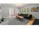 Bright living room with large windows, stylish lighting, and modern furniture and decor at 10293 E Sheri Ln, Englewood, CO 80111