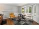 Well-lit office space featuring a work desk, comfortable seating, and hardwood flooring at 10293 E Sheri Ln, Englewood, CO 80111