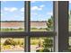 A window view of a park, lake and a stop sign along the crosswalk with lovely, bright, sunny skies at 10293 E Sheri Ln, Englewood, CO 80111