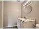 Updated bathroom includes vanity with marble countertop, an oval mirror, updated lighting, and neutral paint at 140 E Highline Cir # 304, Centennial, CO 80122