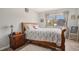 Bedroom features a comfortable queen bed, a wooden bedside table, and neutral paint and wood flooring at 140 E Highline Cir # 304, Centennial, CO 80122