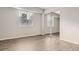 Bedroom features a large mirrored closet, neutral paint, a window with blinds, and wood flooring at 140 E Highline Cir # 304, Centennial, CO 80122