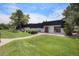A building with a playground and ample green space, including a pathway leading to the red front door at 140 E Highline Cir # 304, Centennial, CO 80122