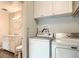 Updated laundry room includes white cabinets above a new washer and dryer next to the updated bathroom at 140 E Highline Cir # 304, Centennial, CO 80122