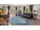 Stylish living room with hardwood floors, large windows, and access to a private balcony at 140 E Highline Cir # 304, Centennial, CO 80122