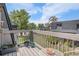 Balcony features wood railings, plants, a table and chairs, with a view of trees and the community at 140 E Highline Cir # 304, Centennial, CO 80122