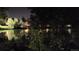 Pond surrounded by trees and bushes, reflecting the lights of nearby buildings at night at 140 E Highline Cir # 304, Centennial, CO 80122