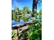 Scenic view of a pond with a fountain, trees, and reflections from a rustic bench at 140 E Highline Cir # 304, Centennial, CO 80122