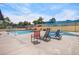Community pool area with several lounge chairs and a hot tub at 140 E Highline Cir # 304, Centennial, CO 80122