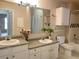 Well-lit bathroom with a double sink vanity, tub with shower, and ample storage space at 1659 Harris St, Superior, CO 80027
