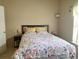 Bright bedroom with a floral bedspread, cozy pillows, and lots of natural light at 1659 Harris St, Superior, CO 80027