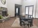 The dining room features a stone fireplace, an elegant dining table with seating for eight, and large bright windows at 1659 Harris St, Superior, CO 80027