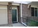 Close-up view of the front door with brick surround and well-maintained exterior at 1659 Harris St, Superior, CO 80027