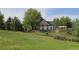 Charming home nestled amidst lush greenery with a stone wall, creating a serene and inviting atmosphere at 1659 Harris St, Superior, CO 80027