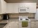 Bright kitchen with white cabinets, appliances, and granite countertops, offering a clean and functional cooking area at 1659 Harris St, Superior, CO 80027
