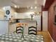 Bright kitchen with white cabinets, track lighting, and a breakfast bar overlooking the dining area at 1659 Harris St, Superior, CO 80027