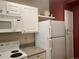 Close-up of the kitchen features white appliances, granite countertops, and ample cabinet space at 1659 Harris St, Superior, CO 80027