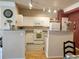 Bright kitchen features white appliances, ample cabinetry, and granite countertops, offering a functional cooking space at 1659 Harris St, Superior, CO 80027