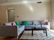 Comfortable living room with gray sectional sofa, patterned rug, and large window offering ample natural light at 1659 Harris St, Superior, CO 80027