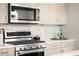 Close-up of the modern kitchen featuring stainless steel appliances and stylish countertops at 1912 W 38Th Ave, Denver, CO 80211