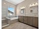 Elegant bathroom with a glass-enclosed shower, soaking tub, and double vanity at 3255 Waterfront Dr, Monument, CO 80132