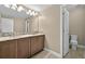 Modern bathroom features dual sinks, granite countertops, mosaic tile backsplash, and tile flooring at 3255 Waterfront Dr, Monument, CO 80132