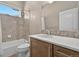 Bright bathroom features a white countertop vanity, a mirror, and a shower-tub combo with tiled walls at 3255 Waterfront Dr, Monument, CO 80132