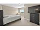 Neutral bedroom features carpet floors, a window with a view, and a black dresser with a large TV on top at 3255 Waterfront Dr, Monument, CO 80132