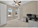 Well-lit bedroom with a ceiling fan, carpet, and large windows offering exterior views at 3255 Waterfront Dr, Monument, CO 80132