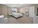 Cozy bedroom has neutral carpet, window, white bedding, and a small writing table to enjoy at 3255 Waterfront Dr, Monument, CO 80132