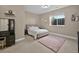 Comfortable bedroom with plush pink rug, neutral walls, double window, and a small nightstand at 3255 Waterfront Dr, Monument, CO 80132