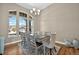 Spacious dining room with large windows, modern chandelier, and seating for eight at 3255 Waterfront Dr, Monument, CO 80132