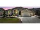Charming stucco home featuring a well-manicured lawn, stone accents, and an attached two-car garage at 3255 Waterfront Dr, Monument, CO 80132