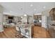 Bright, open kitchen with island seating, stainless appliances, and seamless flow to the living area at 3255 Waterfront Dr, Monument, CO 80132