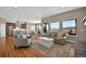 Bright and airy living room with hardwood floors and scenic views from the large windows at 3255 Waterfront Dr, Monument, CO 80132