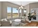 Bright living room with hardwood floors, plush seating, and large windows overlooking a scenic view at 3255 Waterfront Dr, Monument, CO 80132
