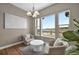 Bright living room with hardwood floors, plush seating, and large windows with an elegant chandelier at 3255 Waterfront Dr, Monument, CO 80132