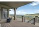 Relax on the porch overlooking water views, featuring neutral tones and rod iron details at 3255 Waterfront Dr, Monument, CO 80132